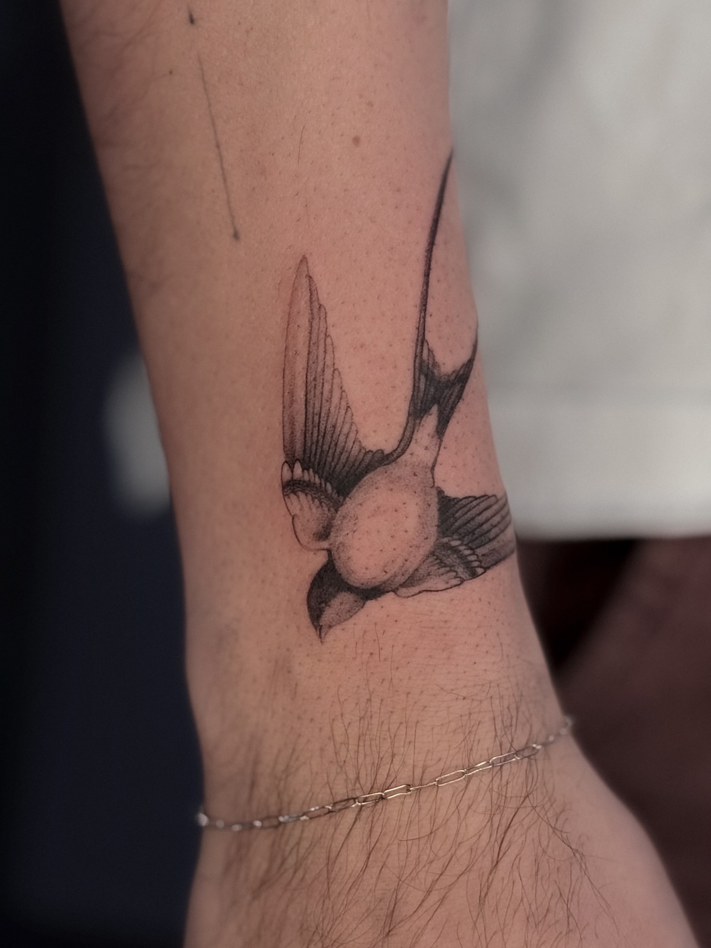 Swallow black and grey tattoo on the forearm by Daria
