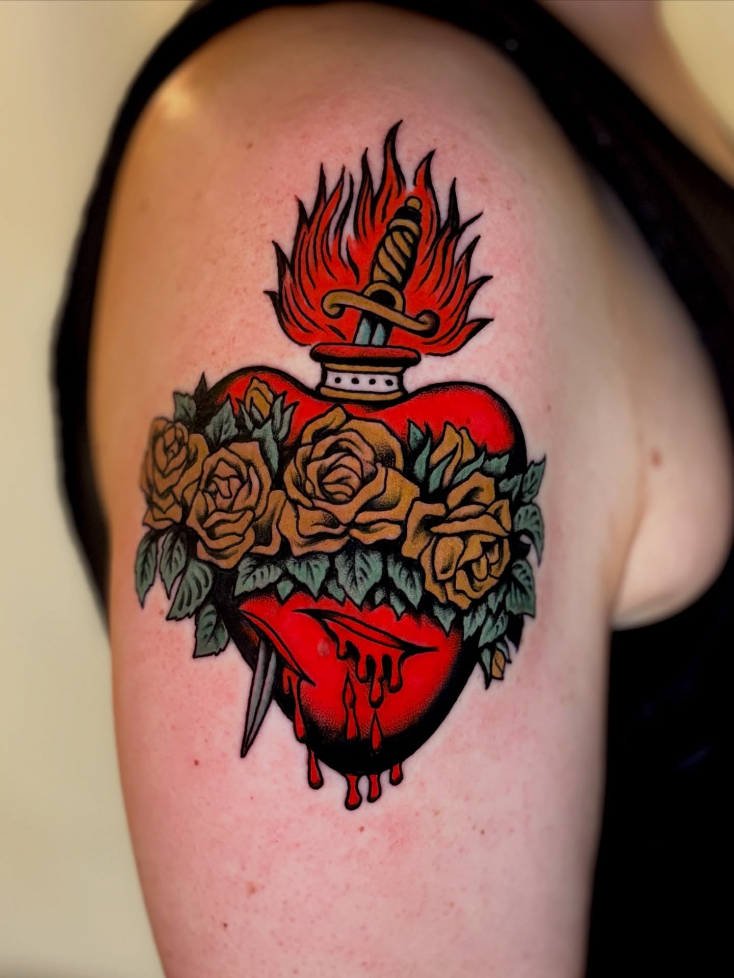 Heart with dagger and roses American traditional tattoo on the shoulder by Weston Imhoff
