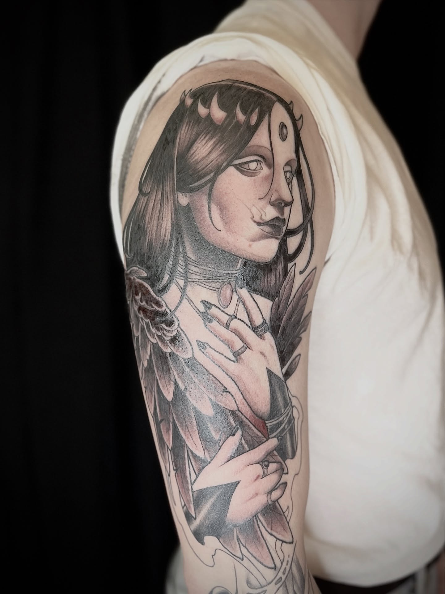 Woman with wings realism tattoo on the upper arm by BELLIE ✧ Tattoo Artist