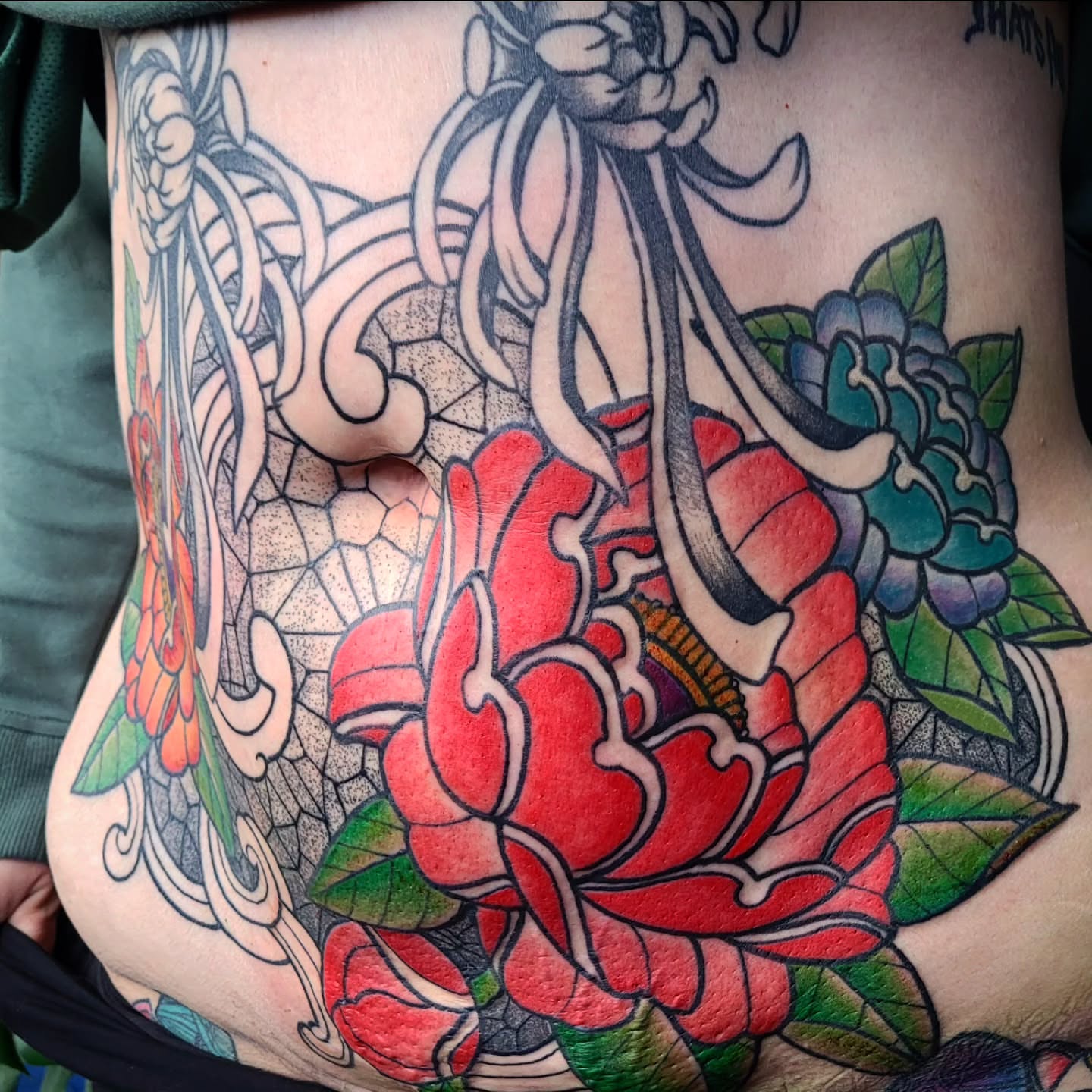 Peony American traditional tattoo on the torso by Ashley Thomas, Midvale, Utah