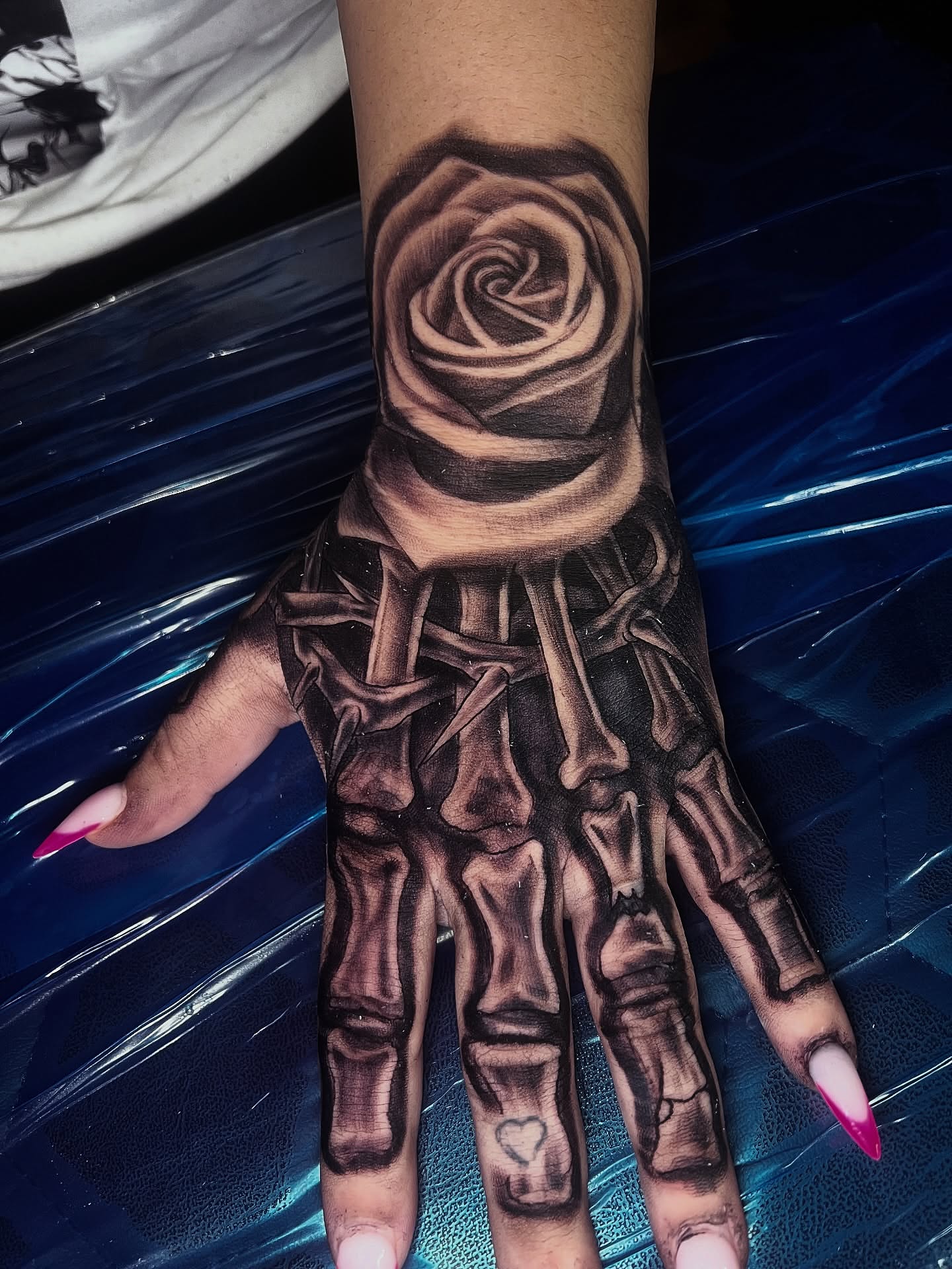 Skeleton hand with rose realism tattoo on the hand by Monstro Ink Arts Tattoos, Bakersfield, California