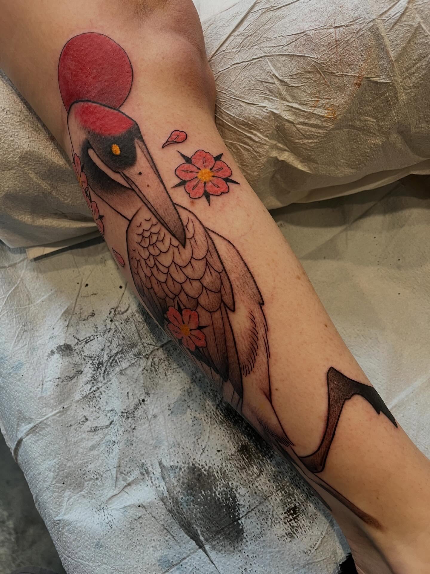 Heron and flowers American traditional tattoo on the forearm by Ian White