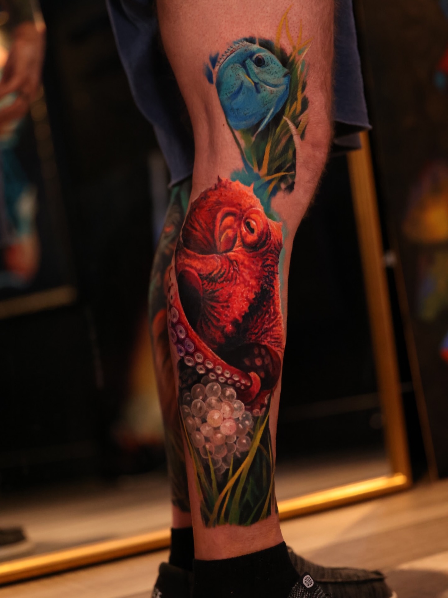 Octopus and fish realism tattoo on the forearm by Brandon Sontag