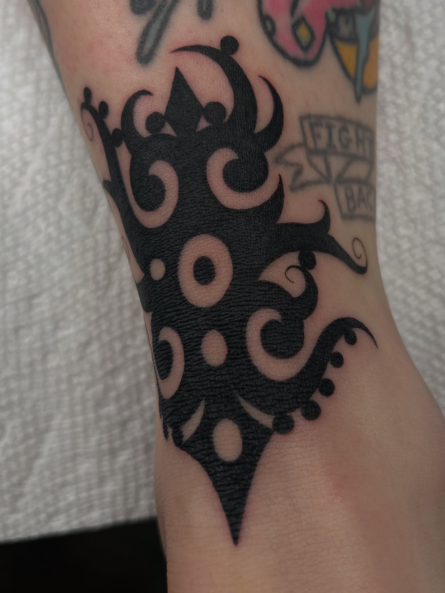 Abstract pattern black and grey tattoo on the forearm by Cassidy Maples