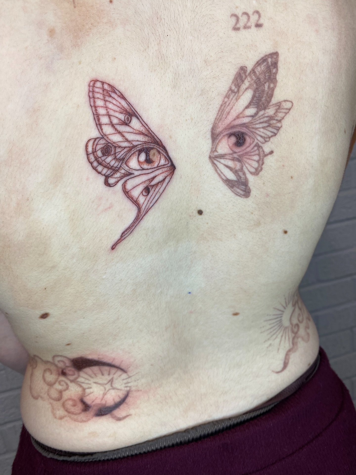 Eyes with butterfly wings dotwork tattoo on the chest by Ellena Reggiani