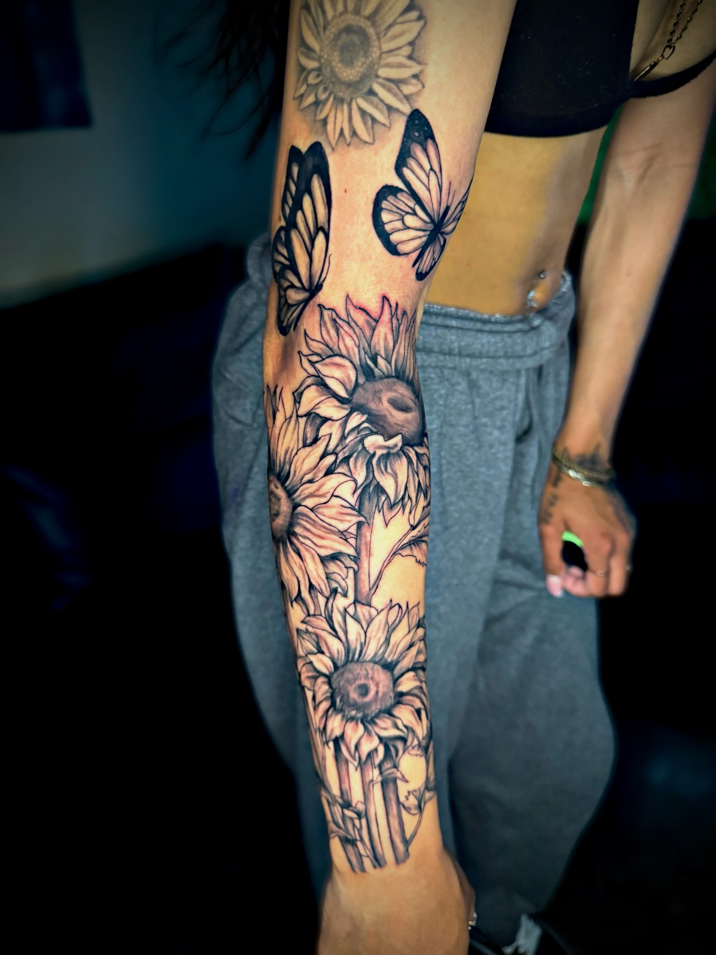 Sunflowers and butterflies realism tattoo on the forearm by Dallas Tattoo Artist📍