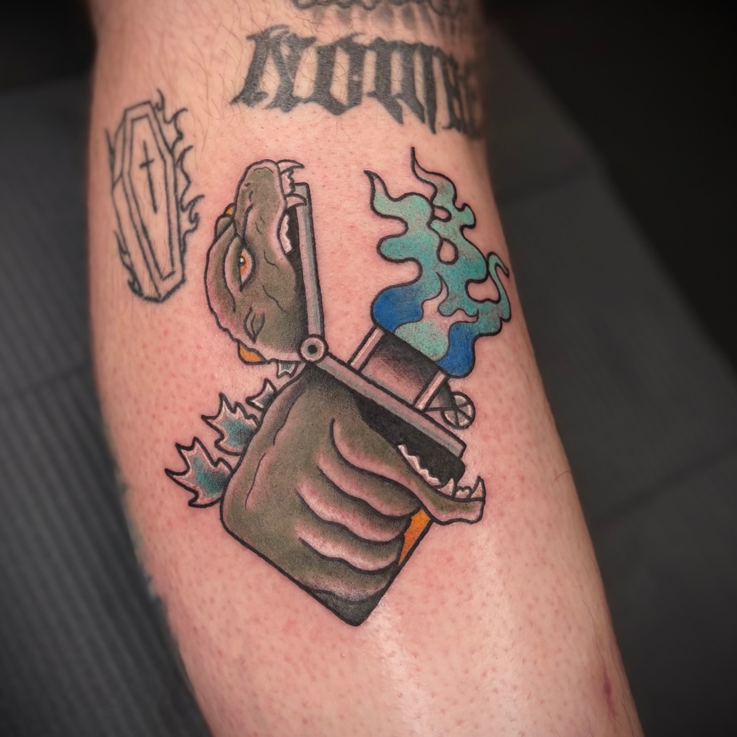 Dinosaur American traditional tattoo on the forearm by Lauren Dempsey, Dearborn, Michigan