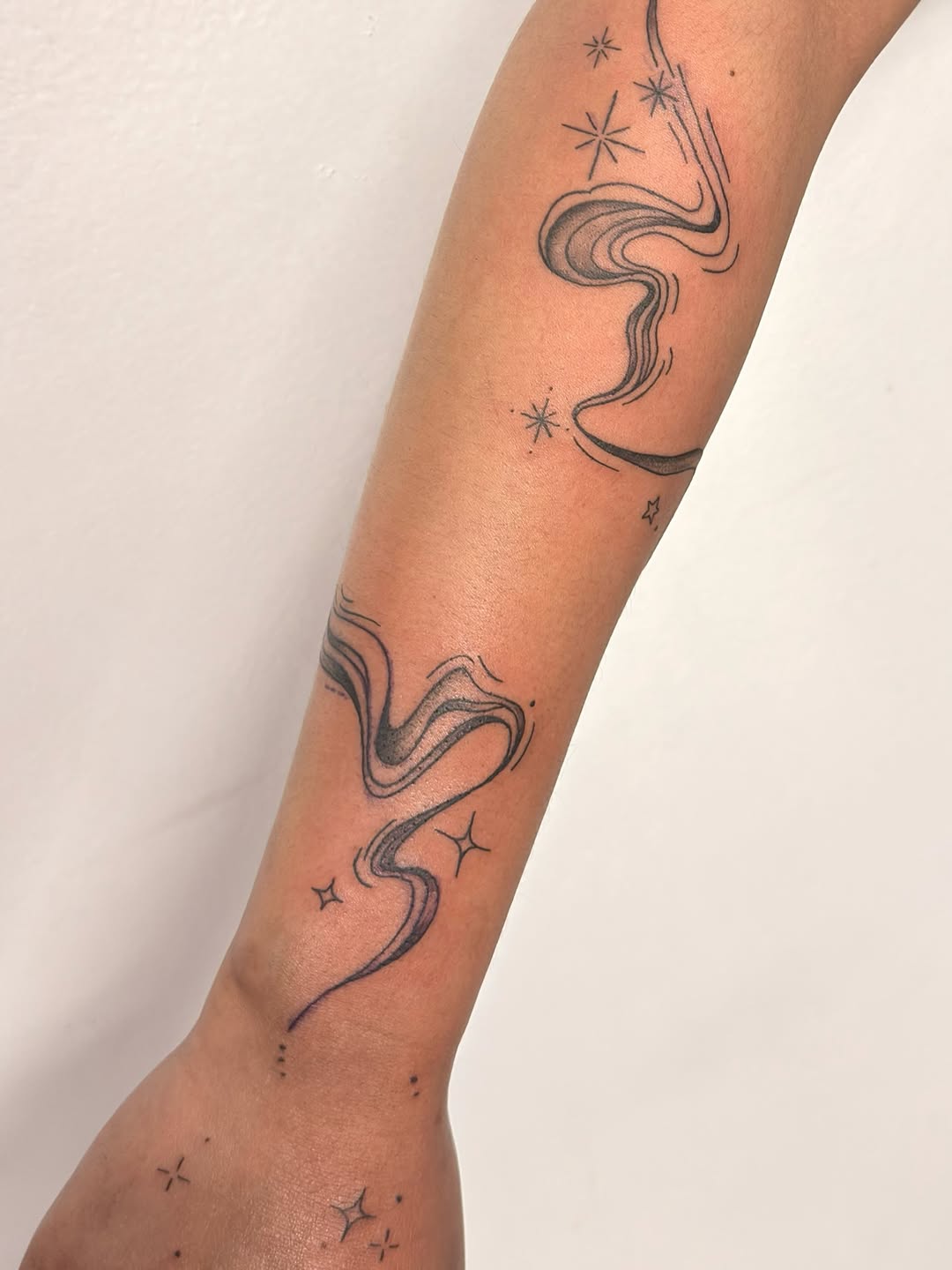 Smoke and stars cyber sigilism tattoo on the forearm by Gerd thINK_TATTOO