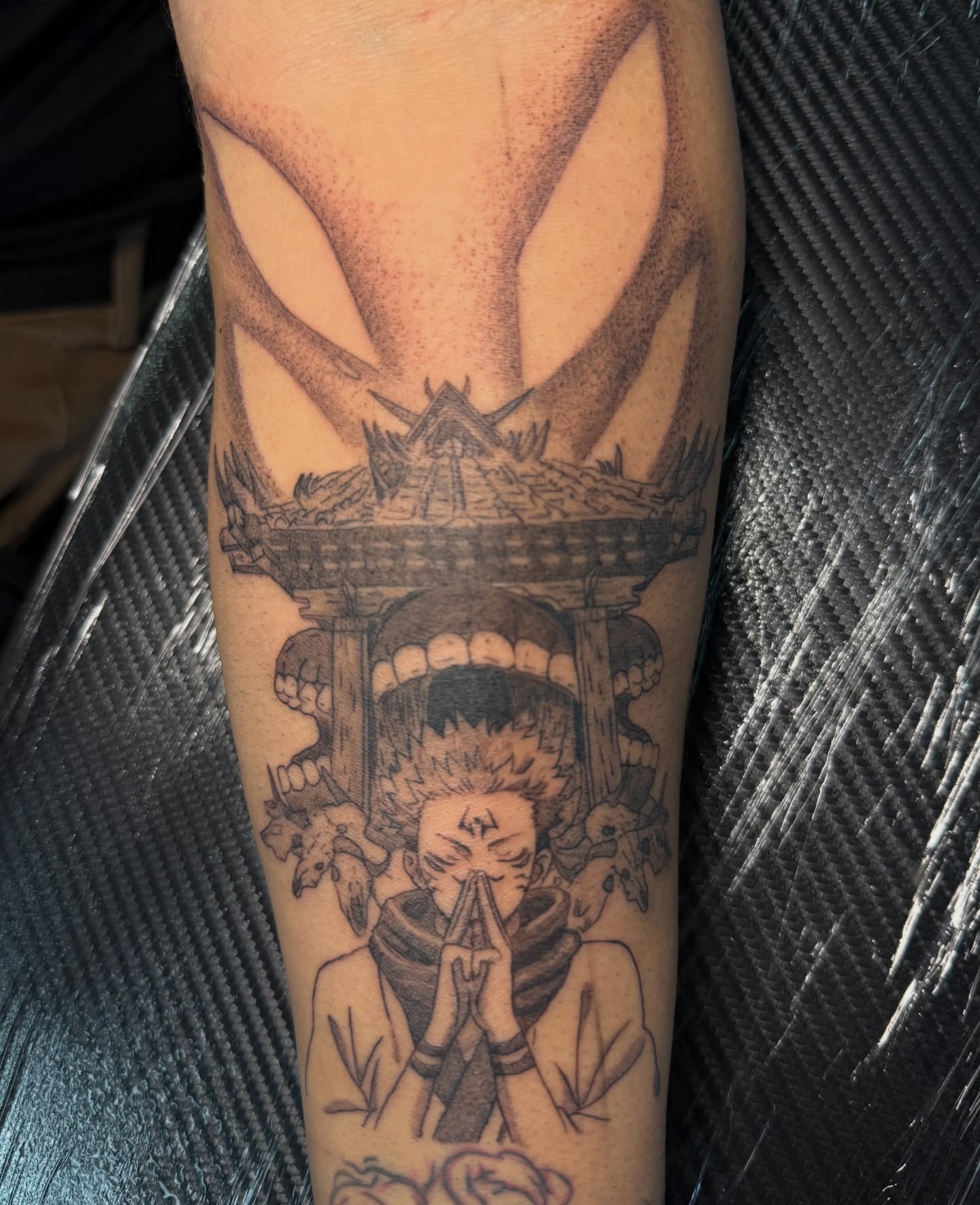 Praying figure with temple dotwork tattoo on the forearm by Kevin, Las Vegas, Nevada