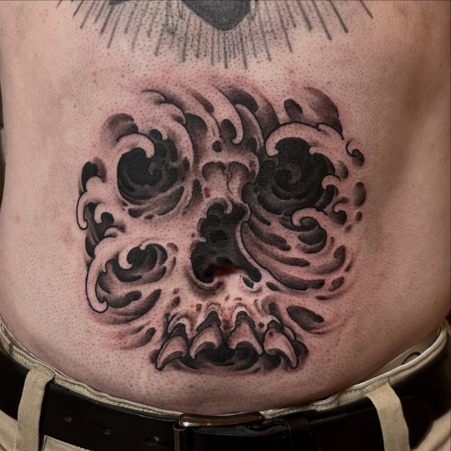 Skull black and grey tattoo on the torso by Justin Weatherholtz, New York, New York