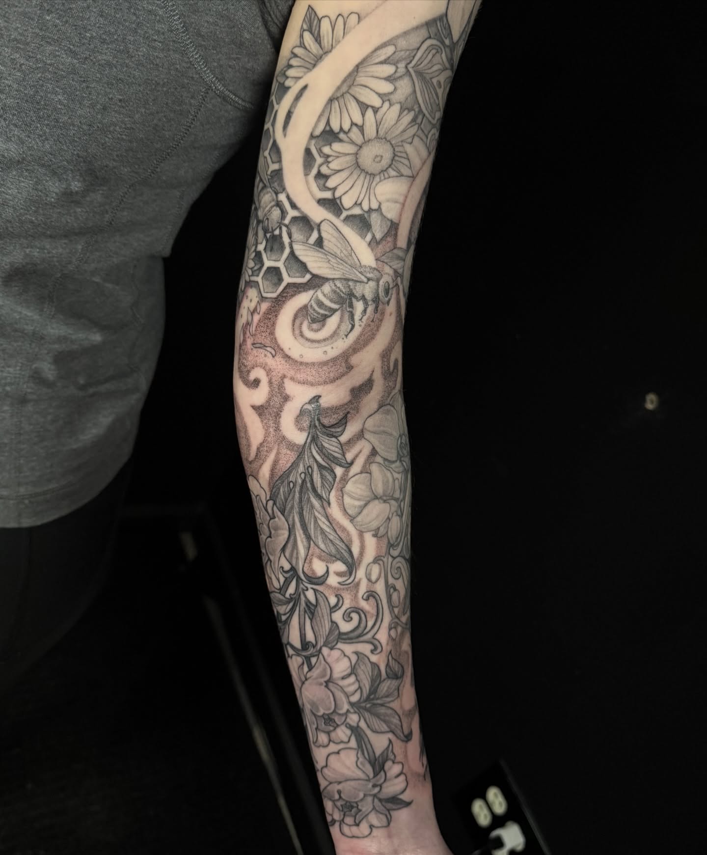 Bees and flowers geometric tattoo on the forearm by Caleb Gesicki