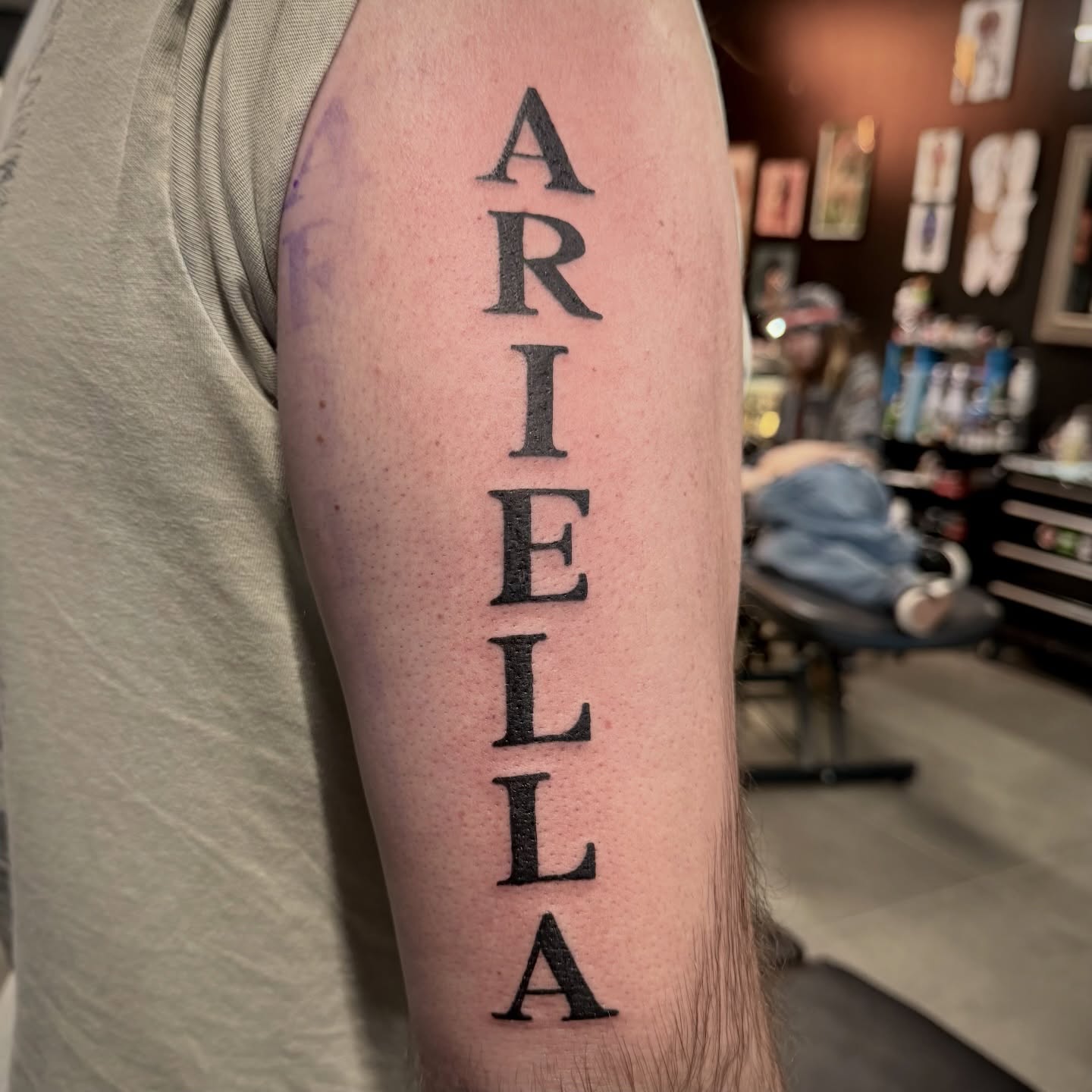 Name lettering script tattoo on the forearm by Seth Christianson
