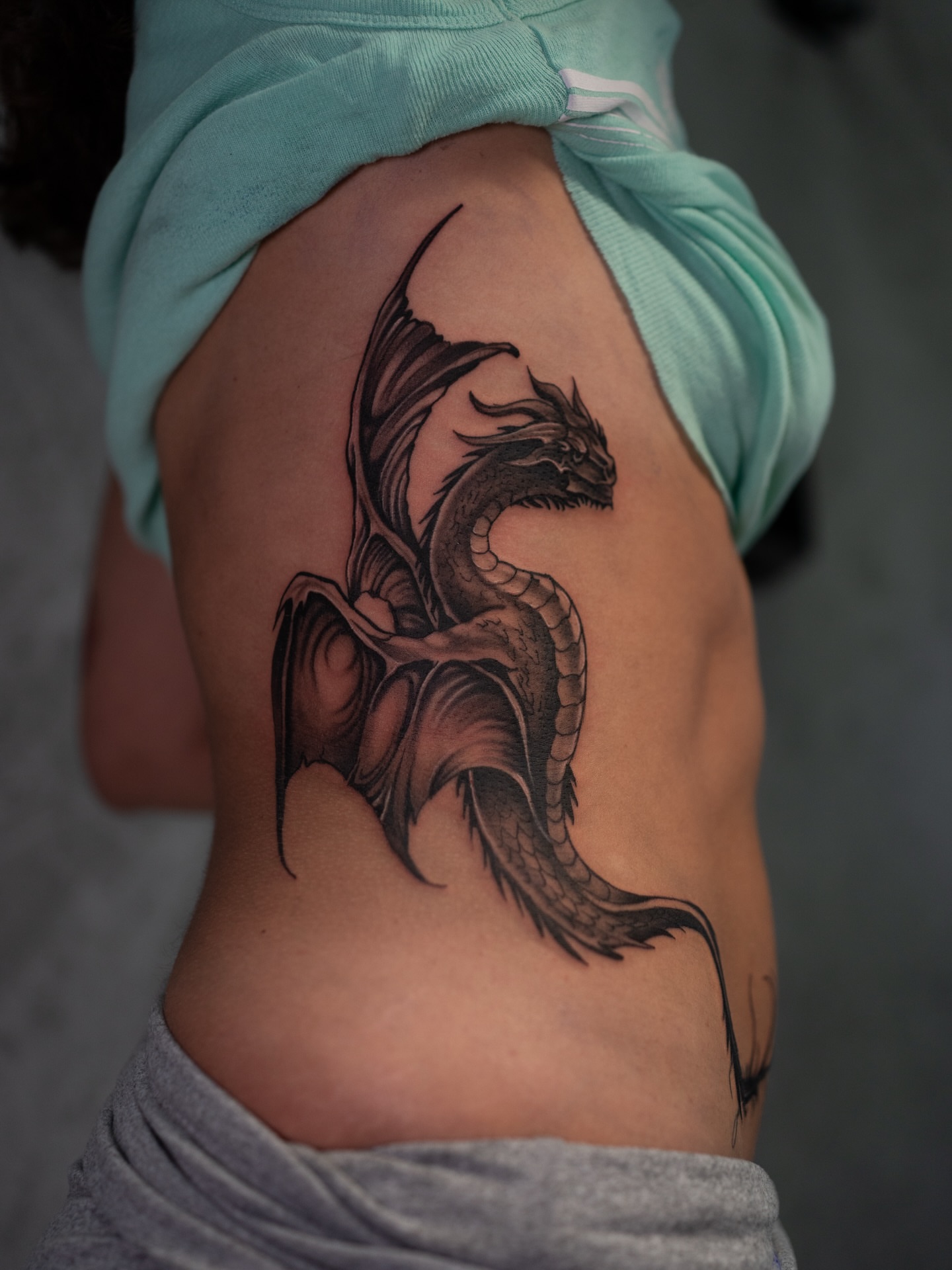 Dragon realism tattoo on the ribs by Damon Valdez