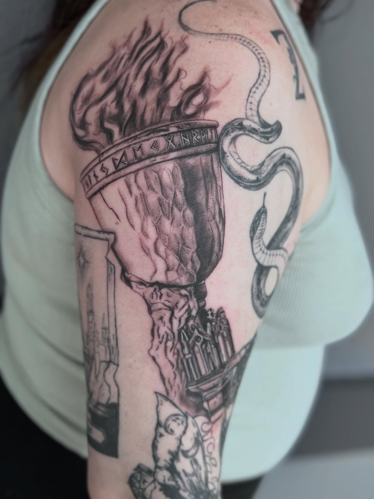 Torch and snake realism tattoo on the shoulder by Gisette Gomez