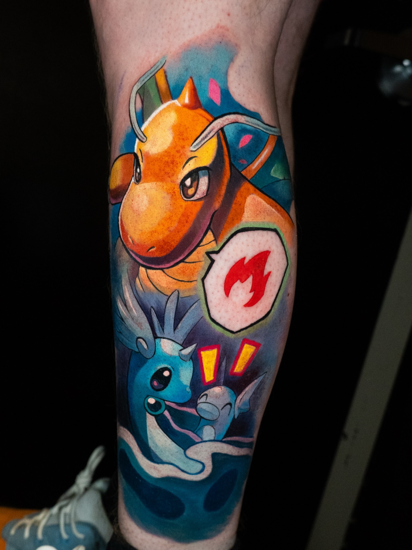 Dragonite and eevee watercolor tattoo on the forearm by ππ§π