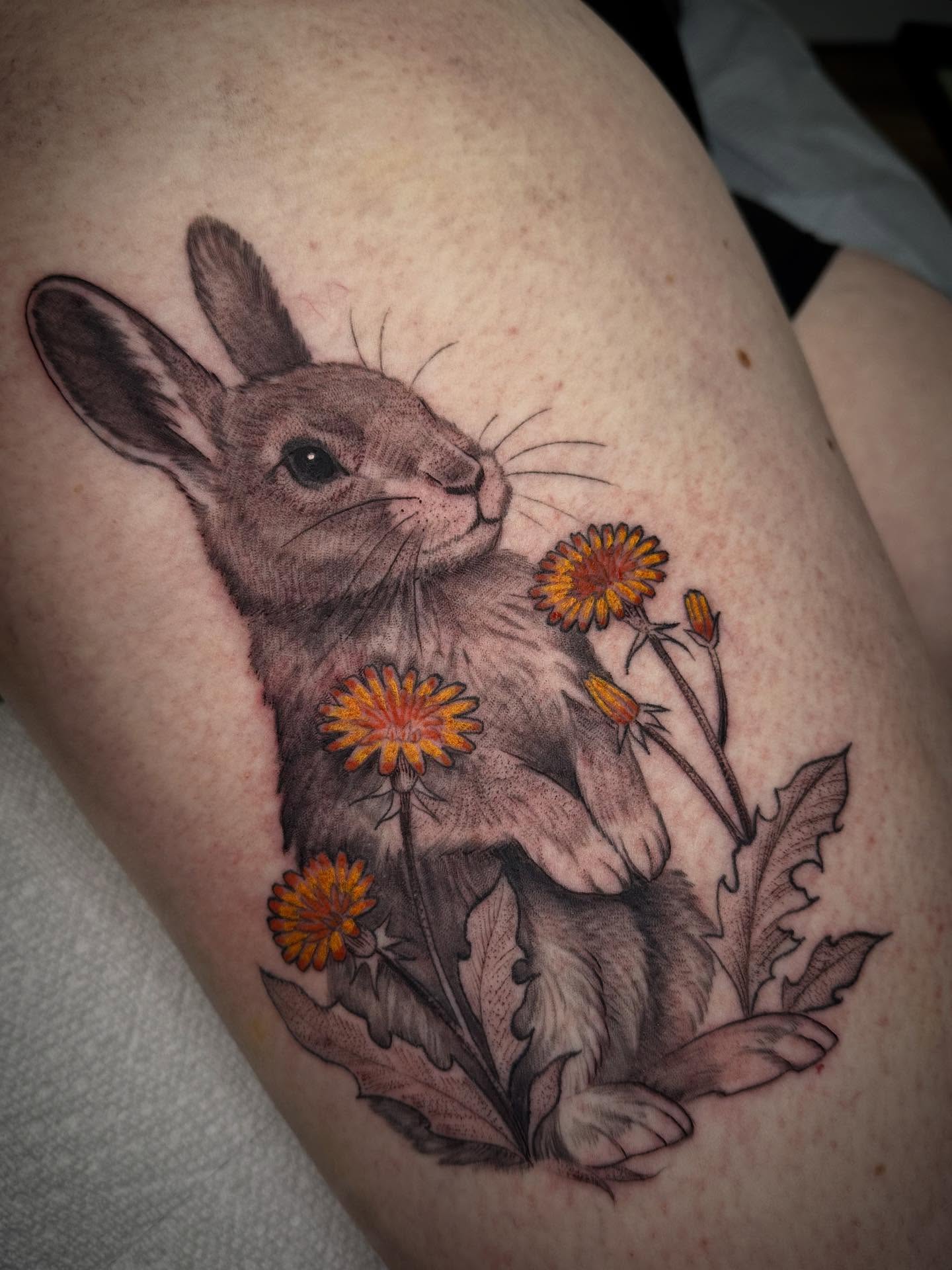 Rabbit among flowers realism tattoo on the thigh by Heather Tattoos Danvers MA