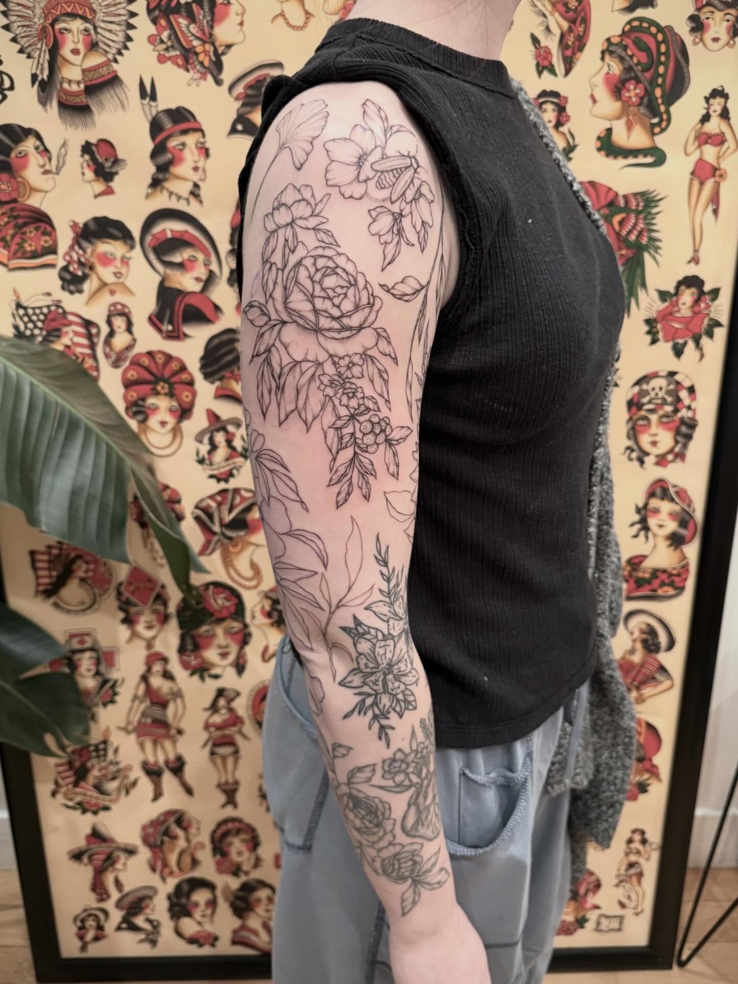 Floral bouquet black and grey tattoo on the upper arm by Daniel Anthony, Philadelphia, Pennsylvania
