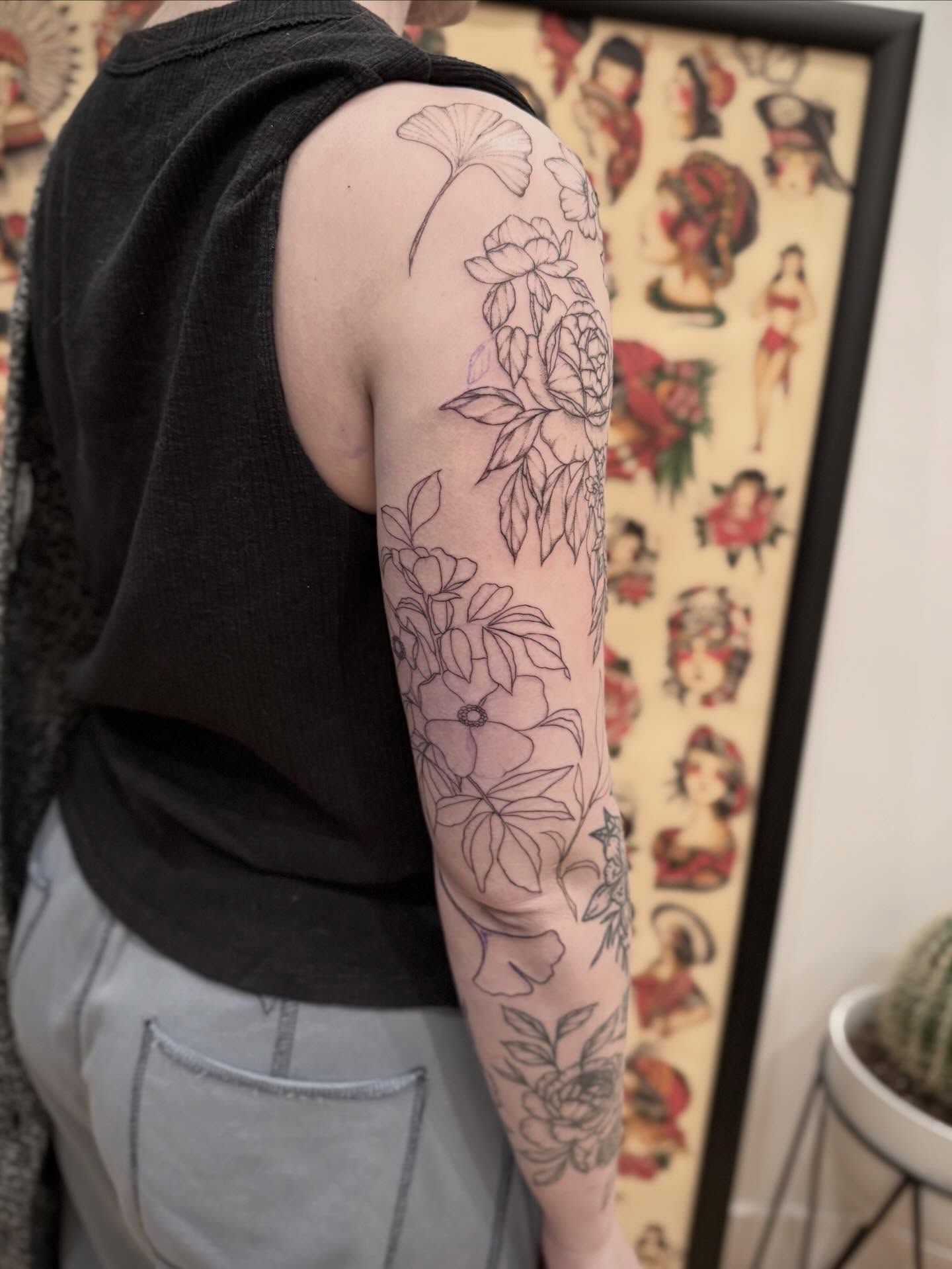 Floral arrangement black and grey tattoo on the upper arm by Daniel Anthony, Philadelphia, Pennsylvania