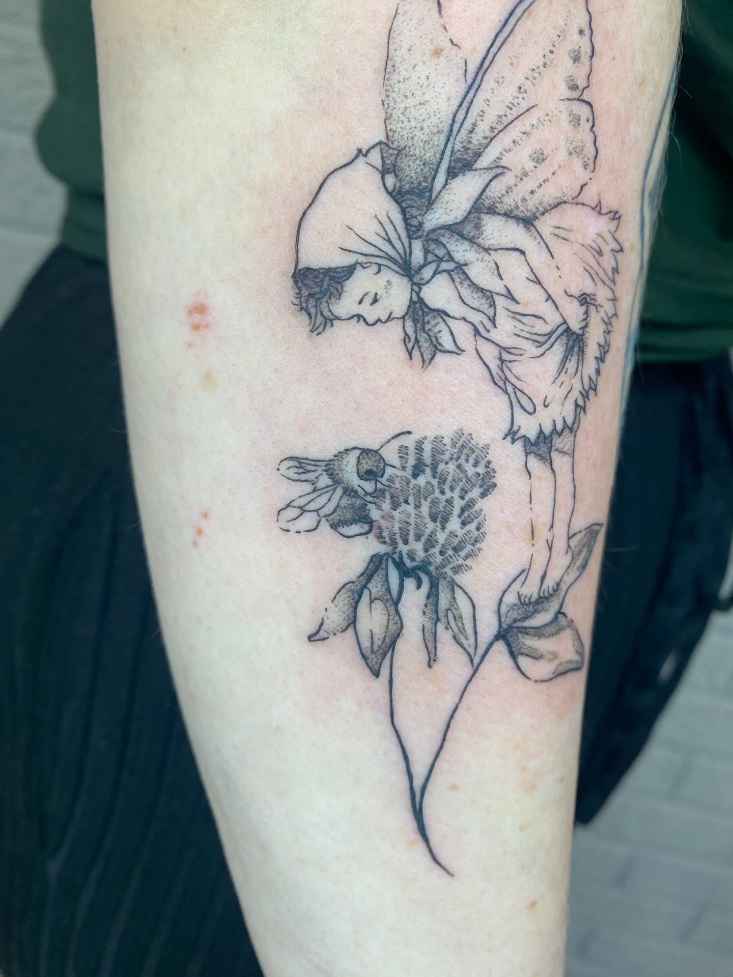 Flower fairy black and grey tattoo on the forearm by Ellena Reggiani