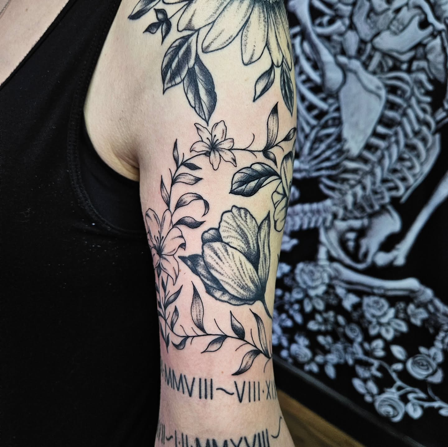 Floral design black and grey tattoo on the forearm by Danny