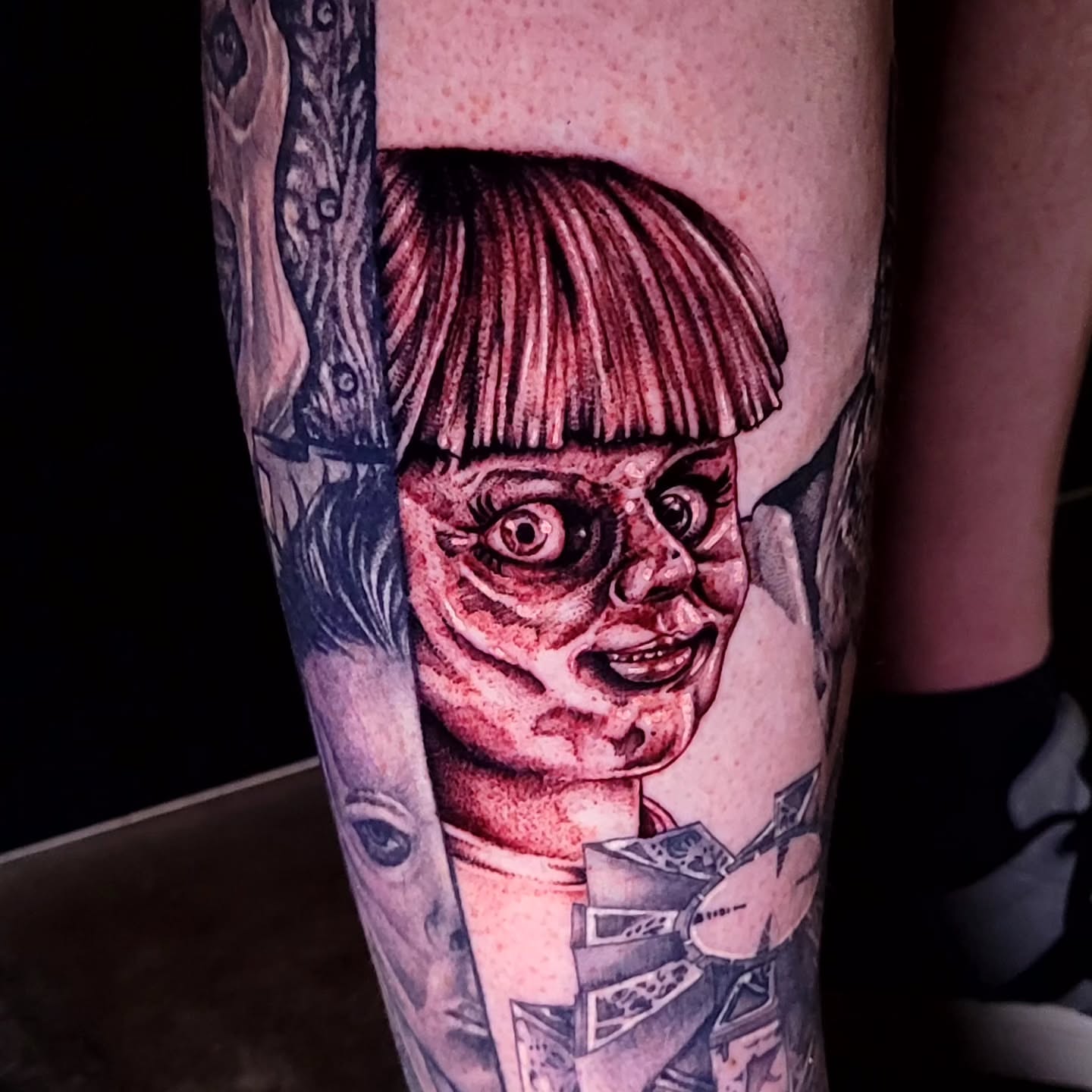 Chucky doll realism tattoo on the forearm by Tyler Monty