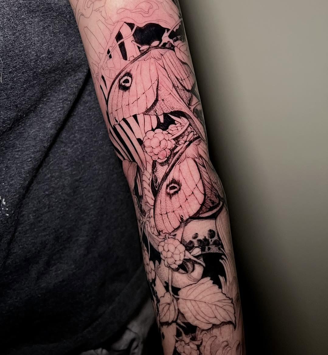 Moths and berries realism tattoo on the forearm by Haylie Adele Strong