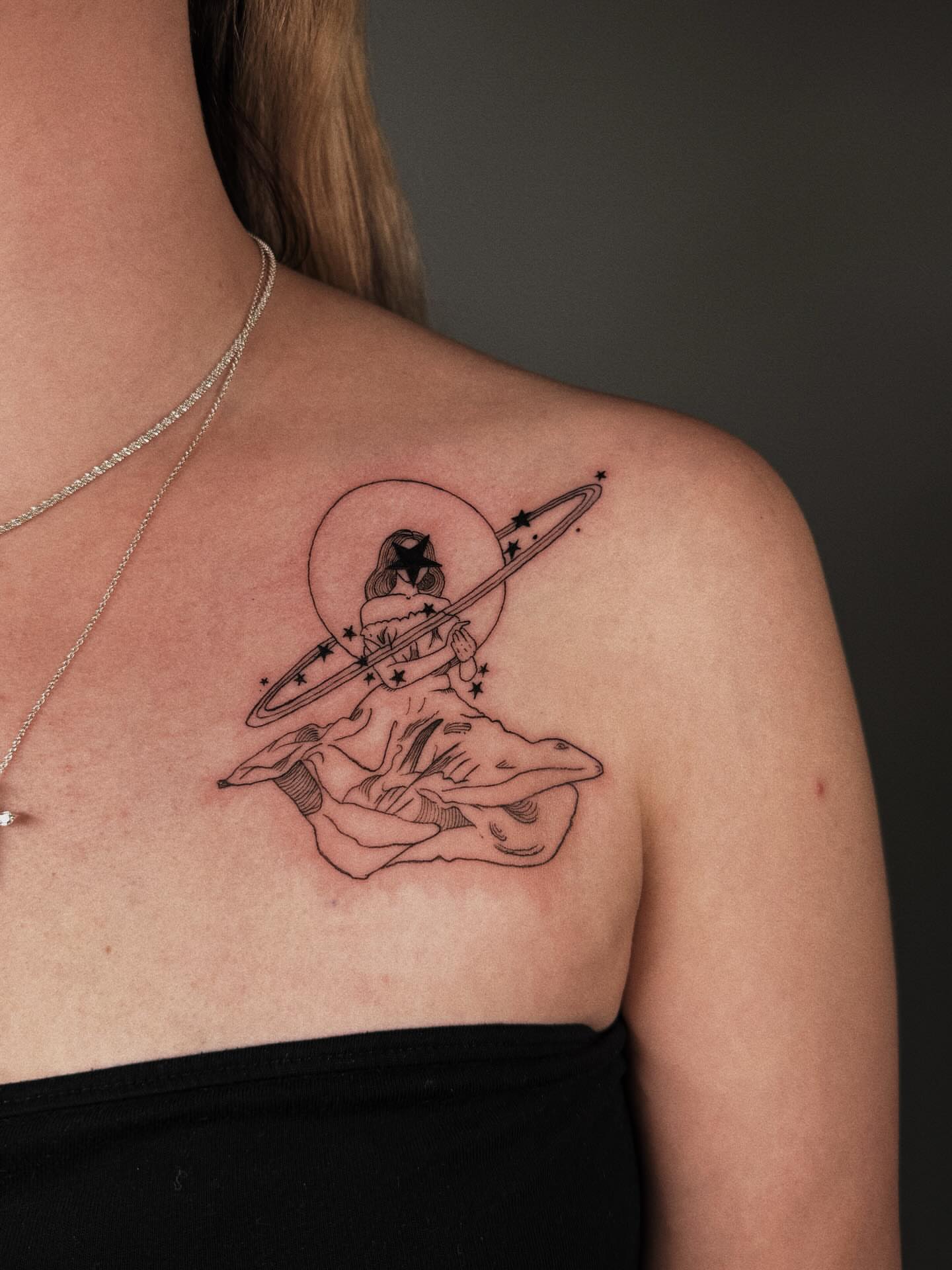 Astronaut black and grey tattoo on the shoulder by Paulina Vazquez