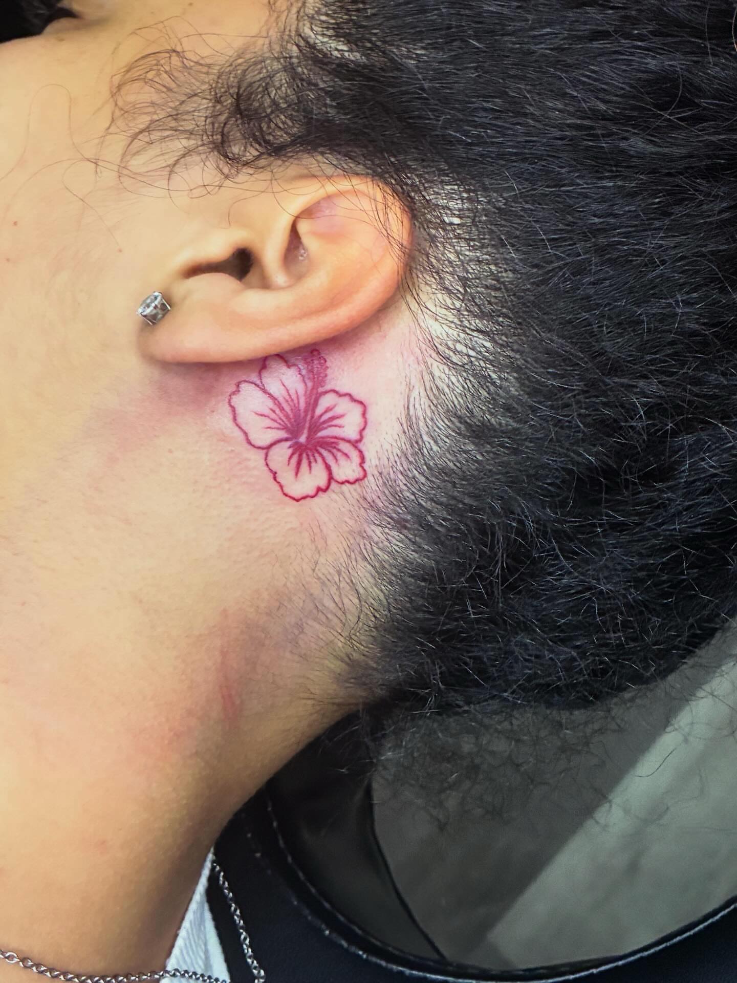 Hawaiian flower dotwork tattoo on the neck by Trae