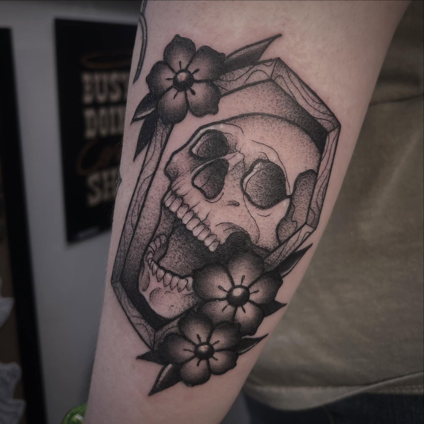 Skull with flowers dotwork tattoo on the forearm by Sarah Foltz