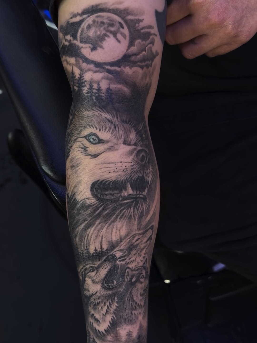 Wolf pack under moon realism tattoo on the forearm by 🐺