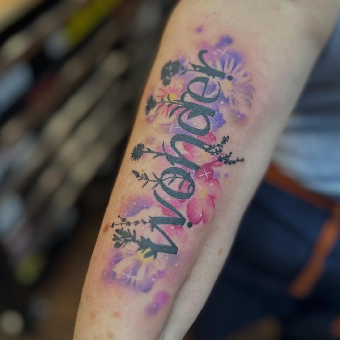 Wonder watercolor tattoo on the forearm by Megan Sierra