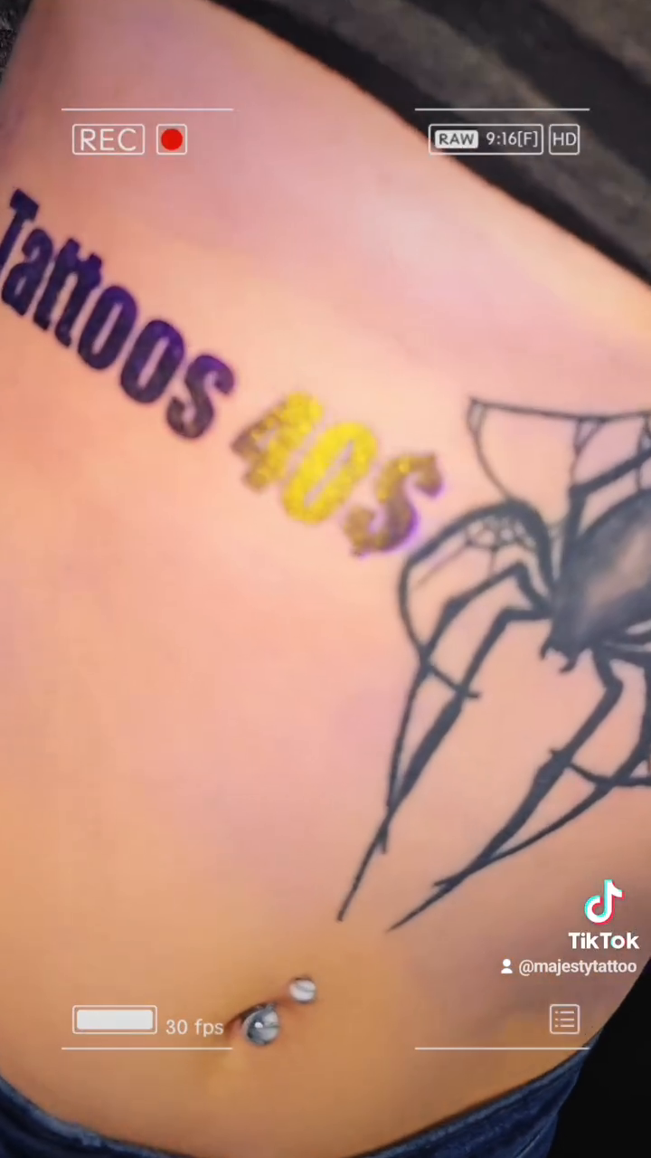 Spider and text tattoo blackwork tattoo on the torso by Majesty Selvera