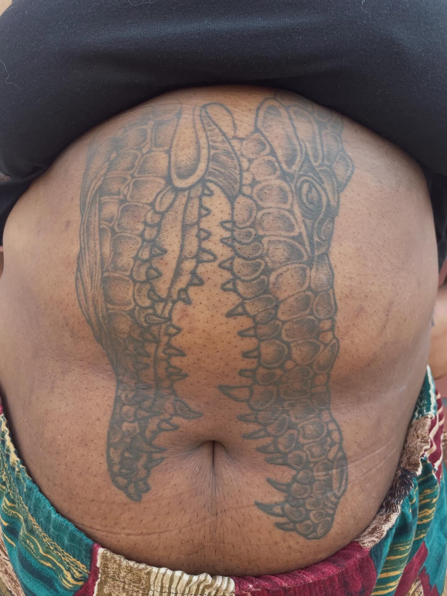 Alligator black and grey tattoo on the torso by Fionna Fanning
