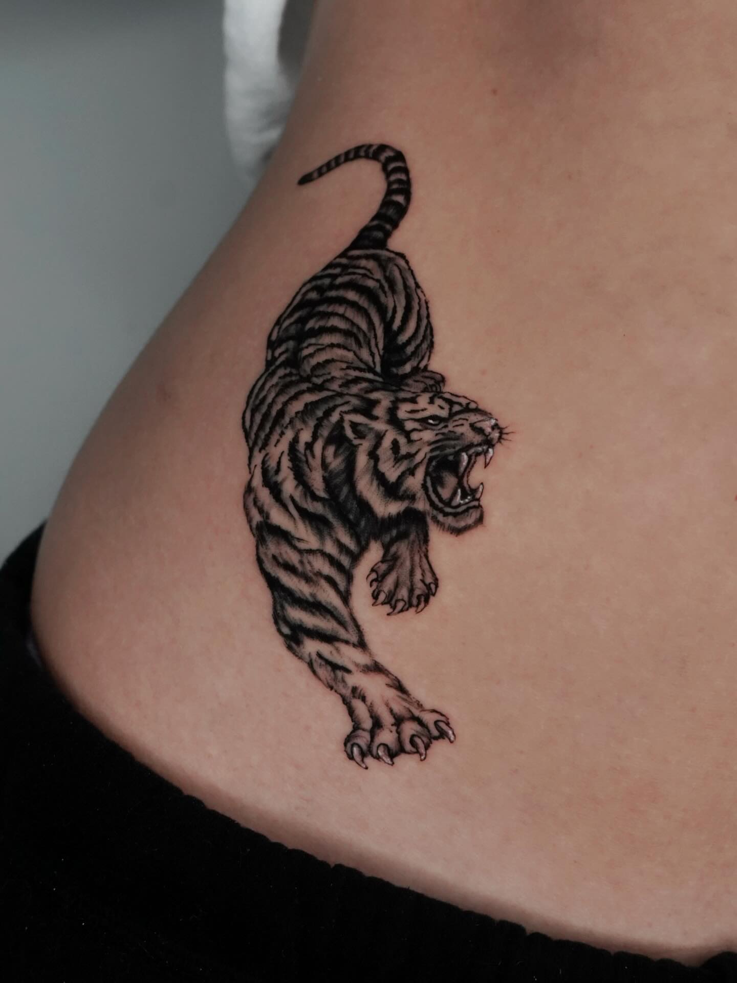 Roaring tiger black and grey tattoo on the back by Carlos Trujillo