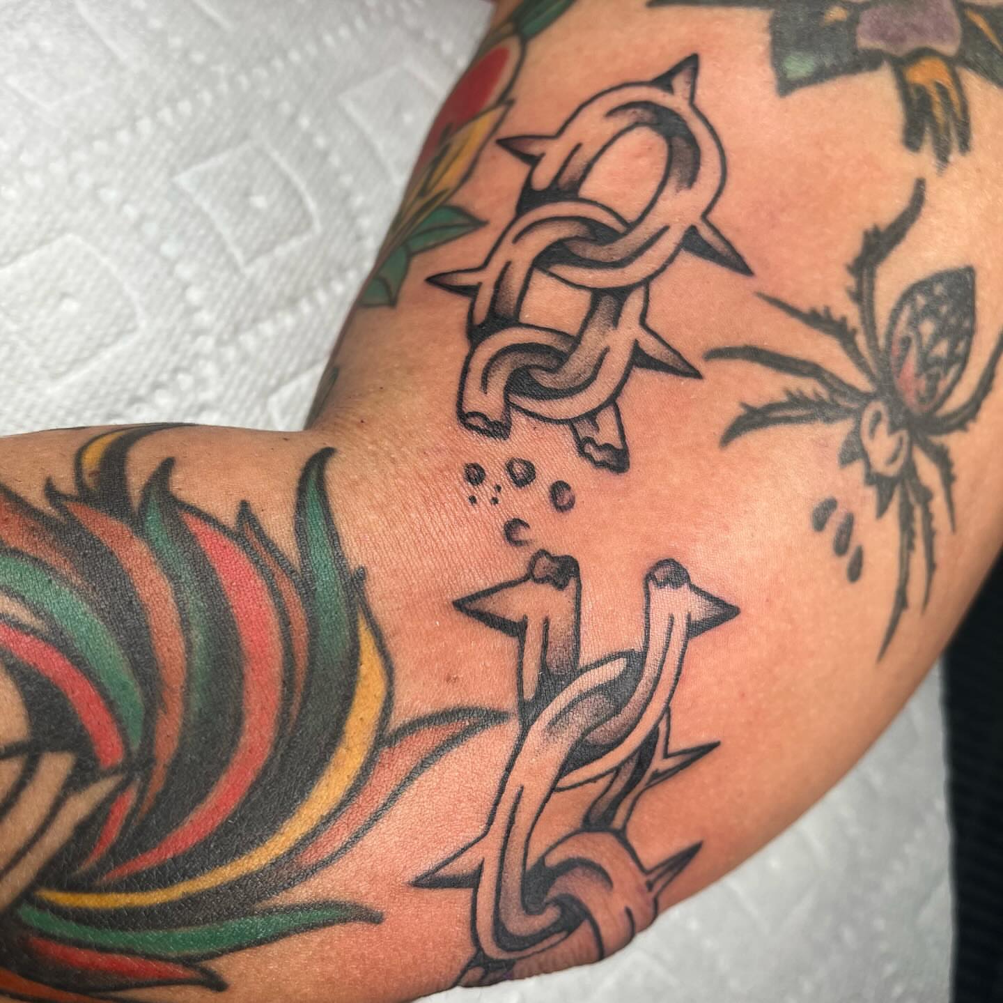 Abstract knot American traditional tattoo on the forearm by Jennifer Medrano