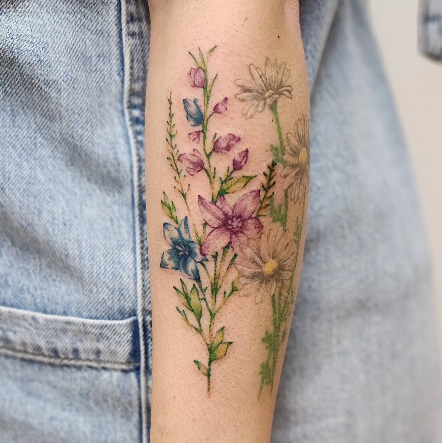 Floral arrangement watercolor tattoo on the forearm by Sonya ๐ฟ๐ธ๐พ