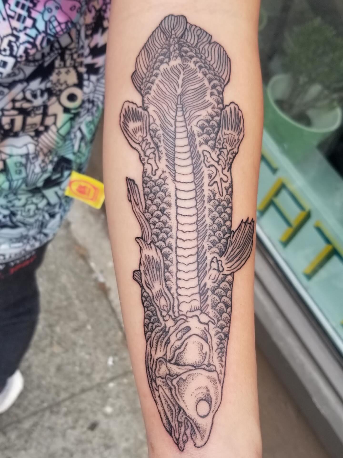 Fish black and grey tattoo on the forearm by Jason Middelton