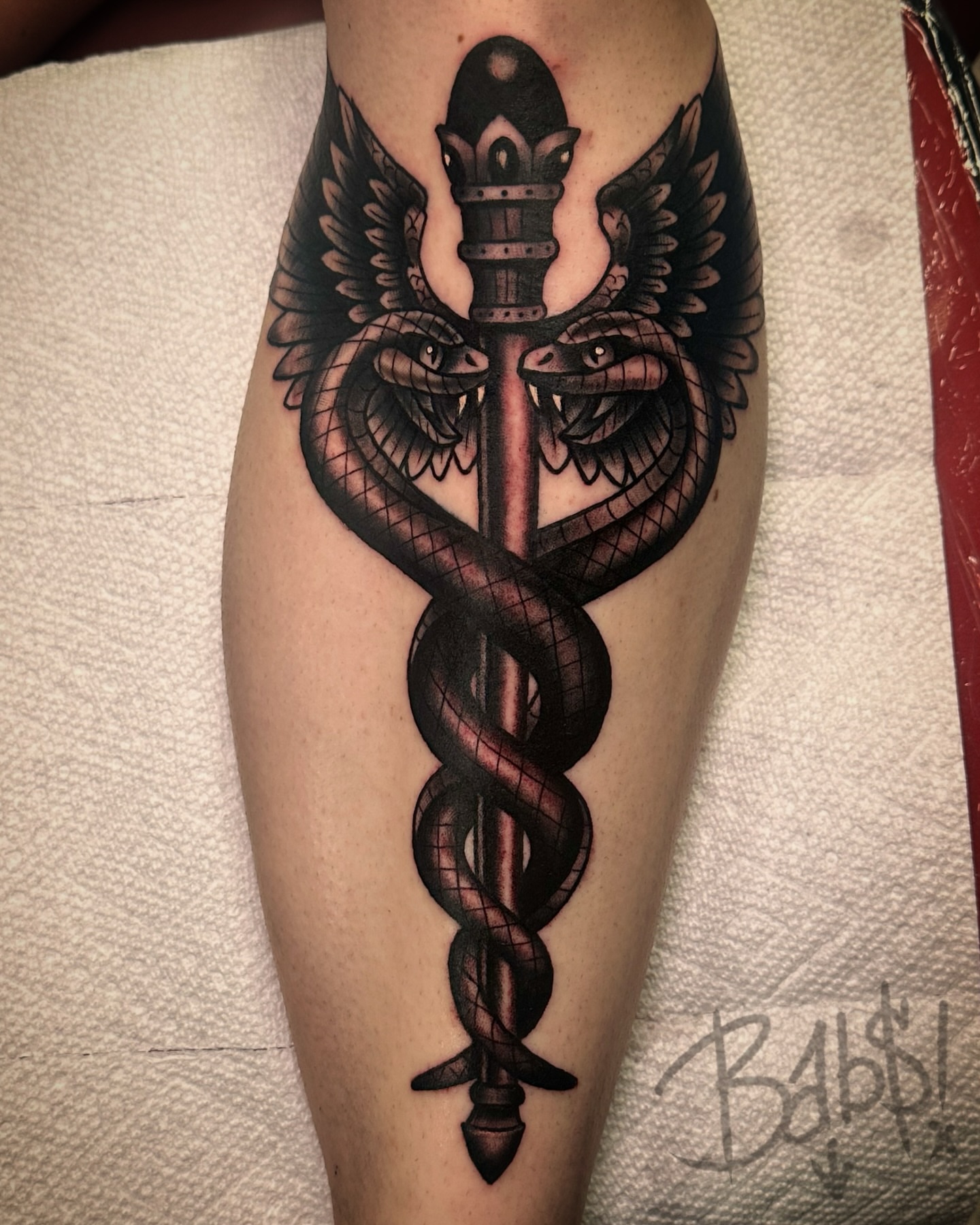 Caduceus black and grey tattoo on the forearm by Justin B