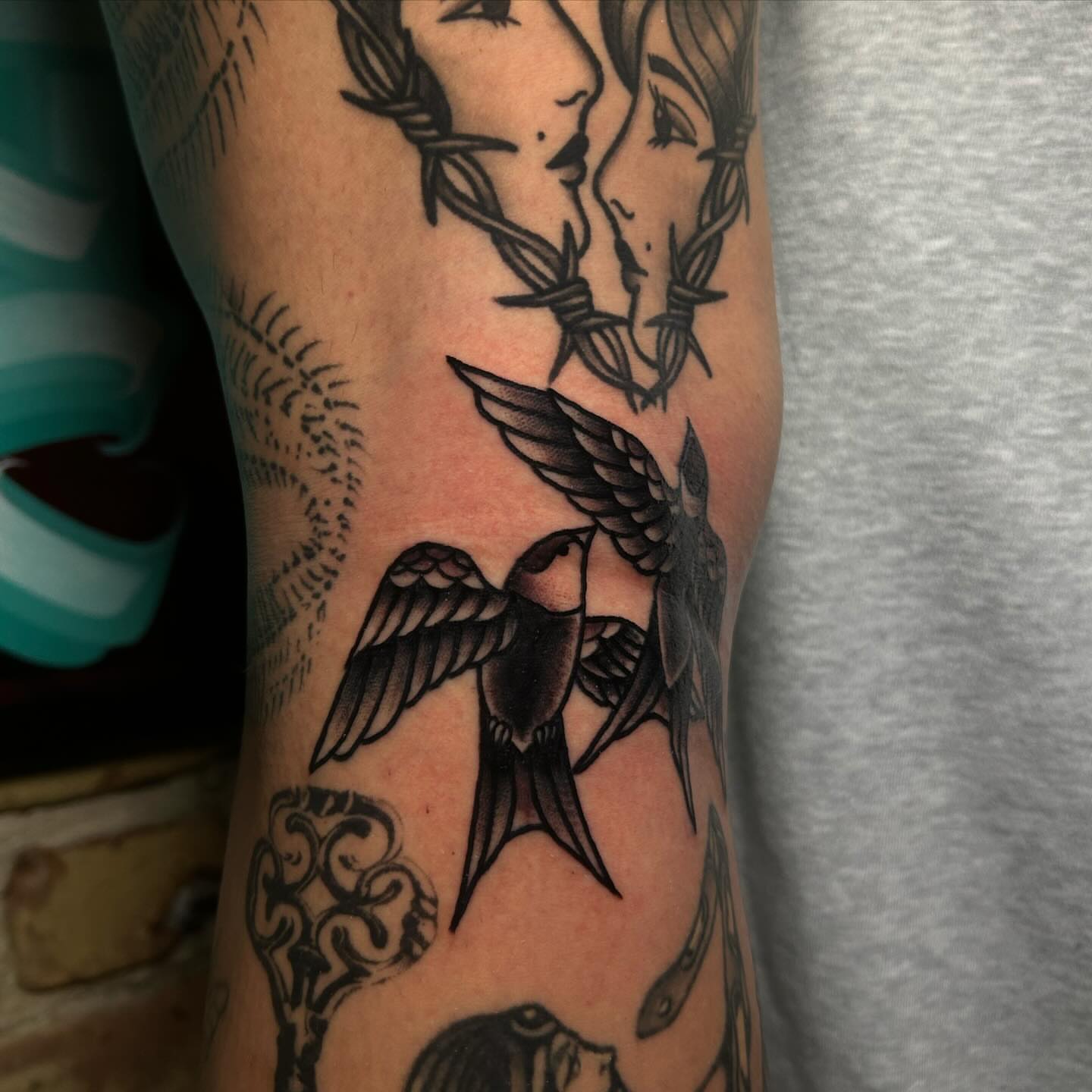 Swallows and wreath American traditional tattoo on the forearm by Alycia