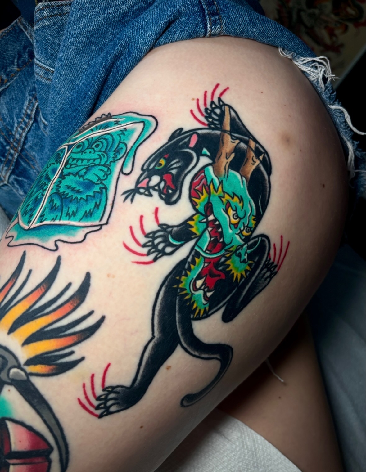 Panther and dragon American traditional tattoo on the thigh by Mickey Putillo, Charlotte, North Carolina