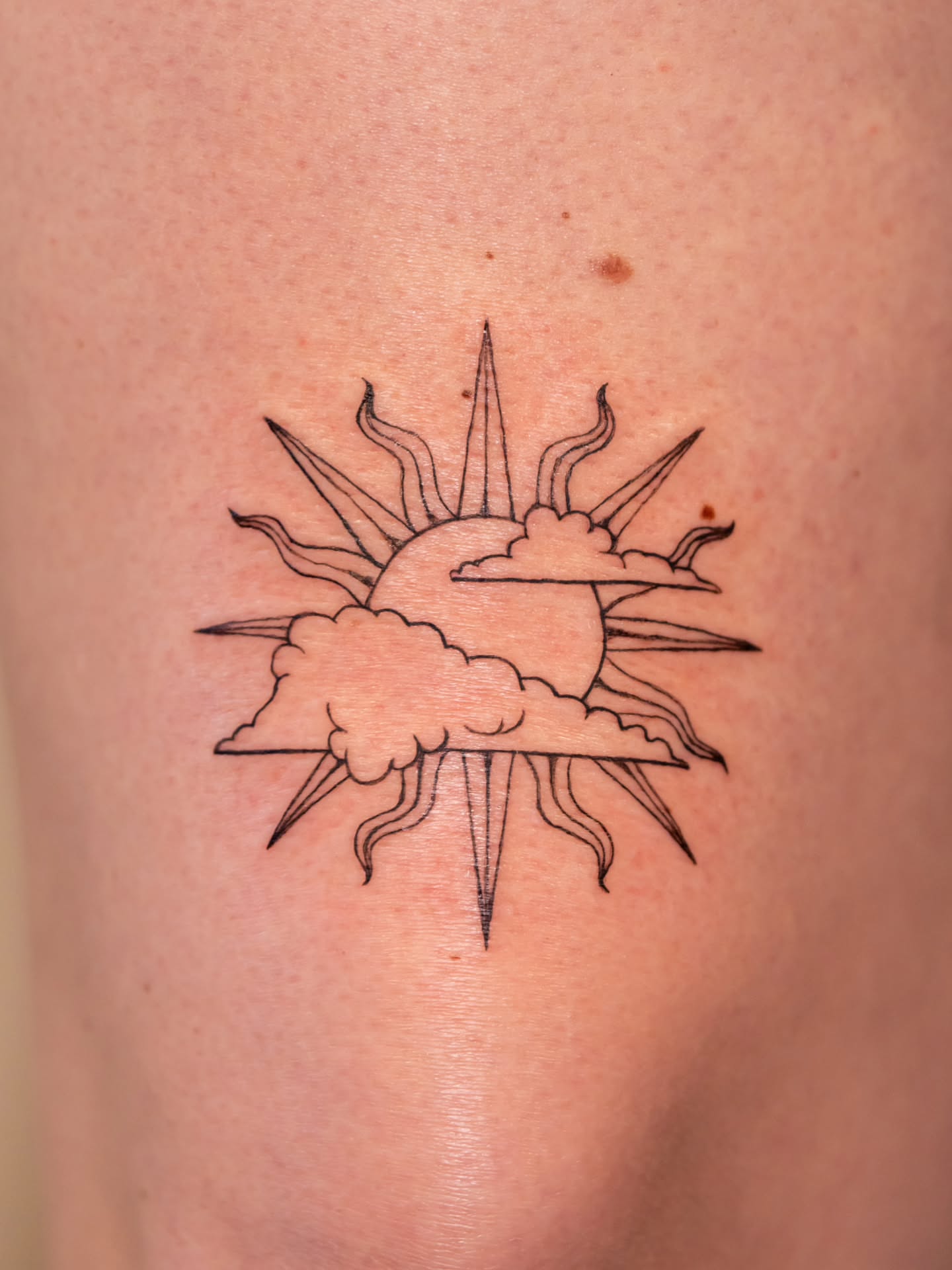 Sun and clouds black and grey tattoo on the forearm by Alex ▪︎ Tattoo Apprentice