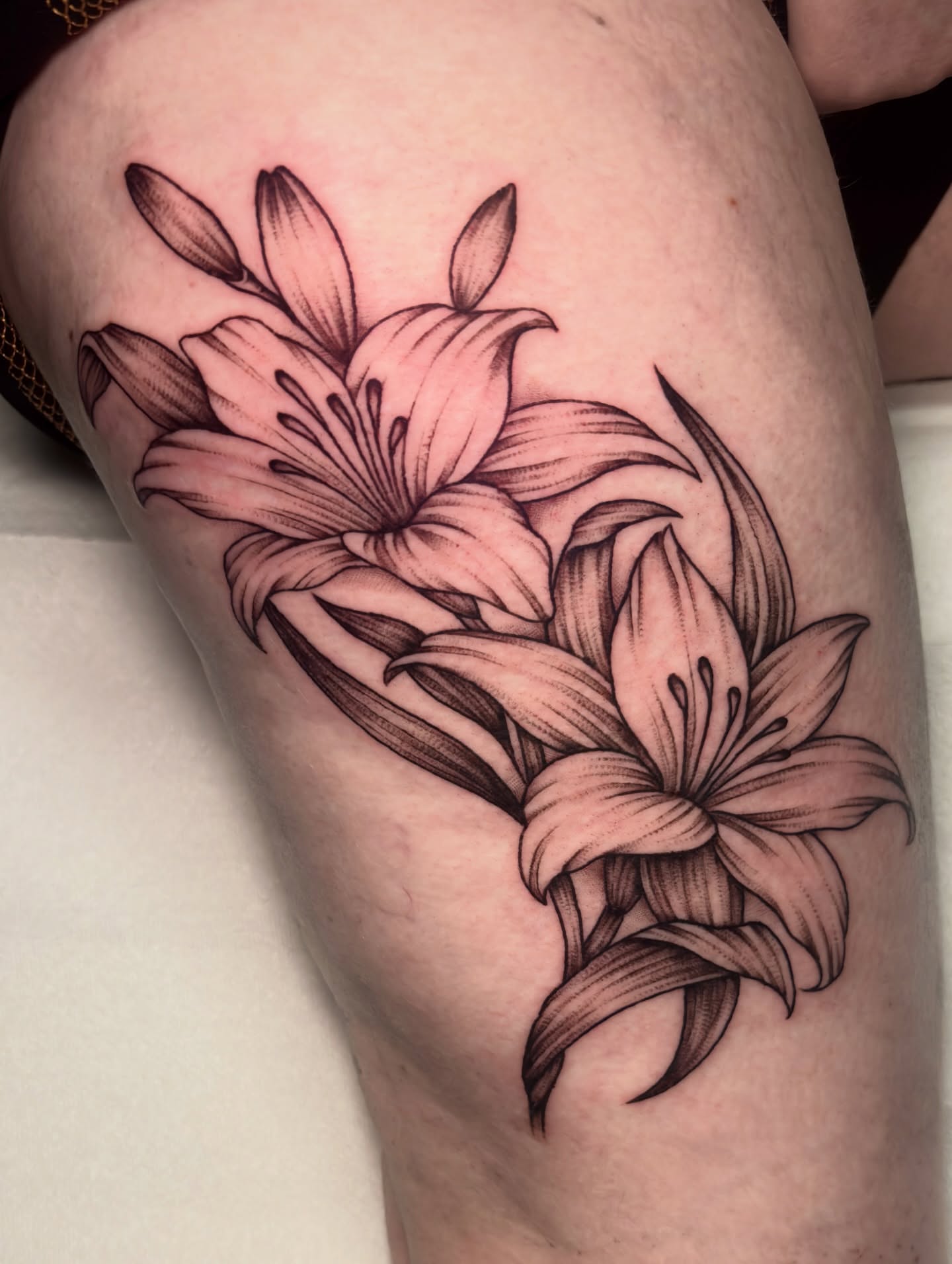 Lilies black and grey tattoo on the thigh by Matt Elliott, Murfreesboro, Tennessee