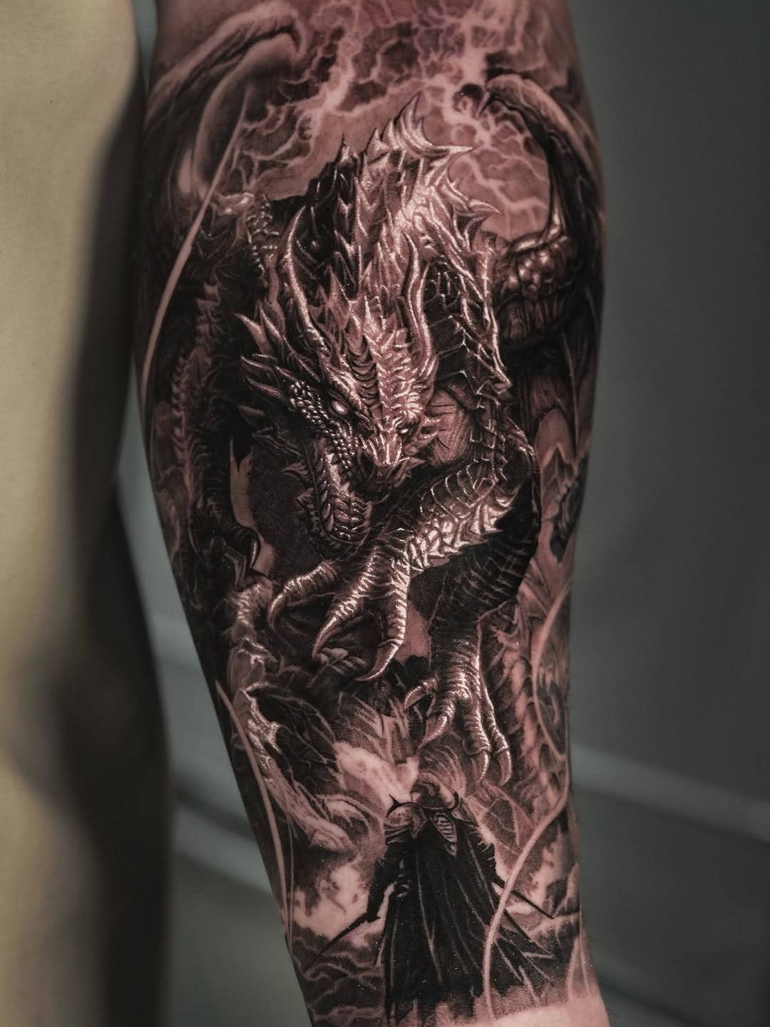 Dragon and warrior realism tattoo on the forearm by Sumok Kim