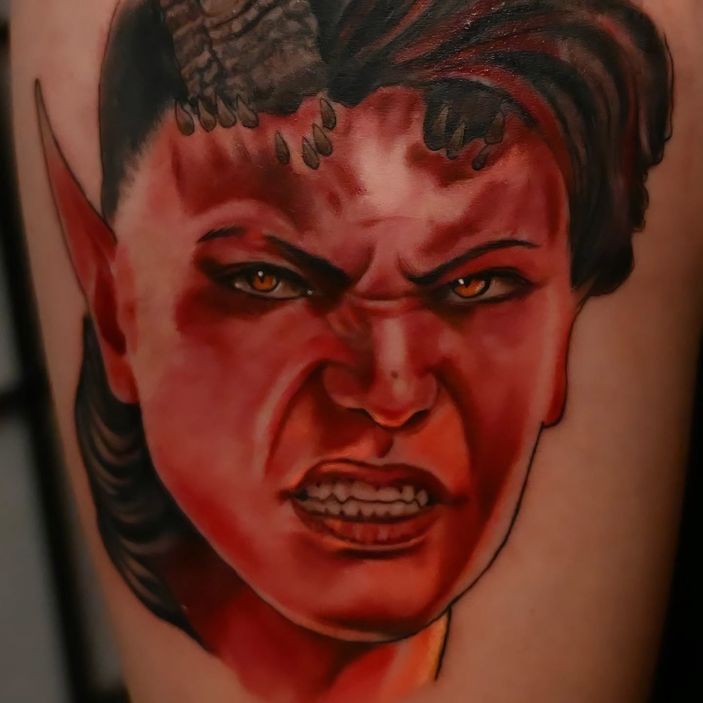 Angry face realism tattoo on the forearm by Michael ORegan
