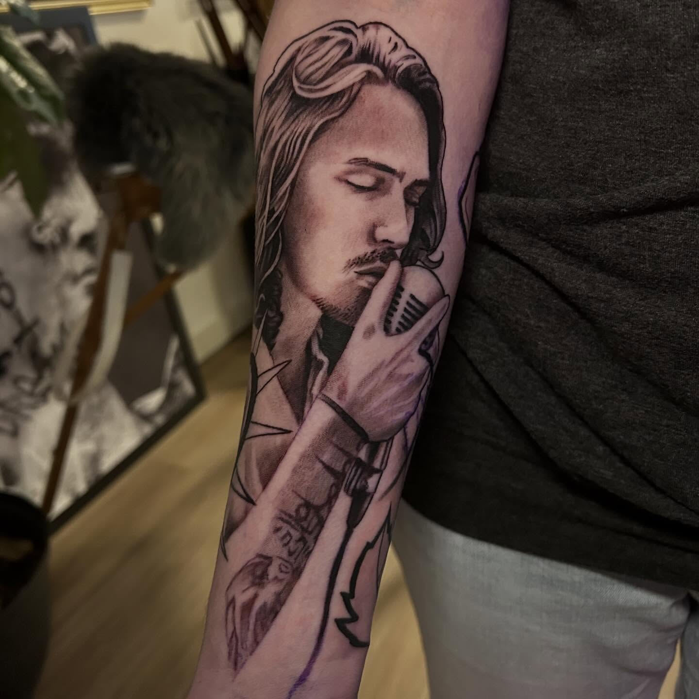 Singer with microphone realism tattoo on the forearm by Whitney Harbin
