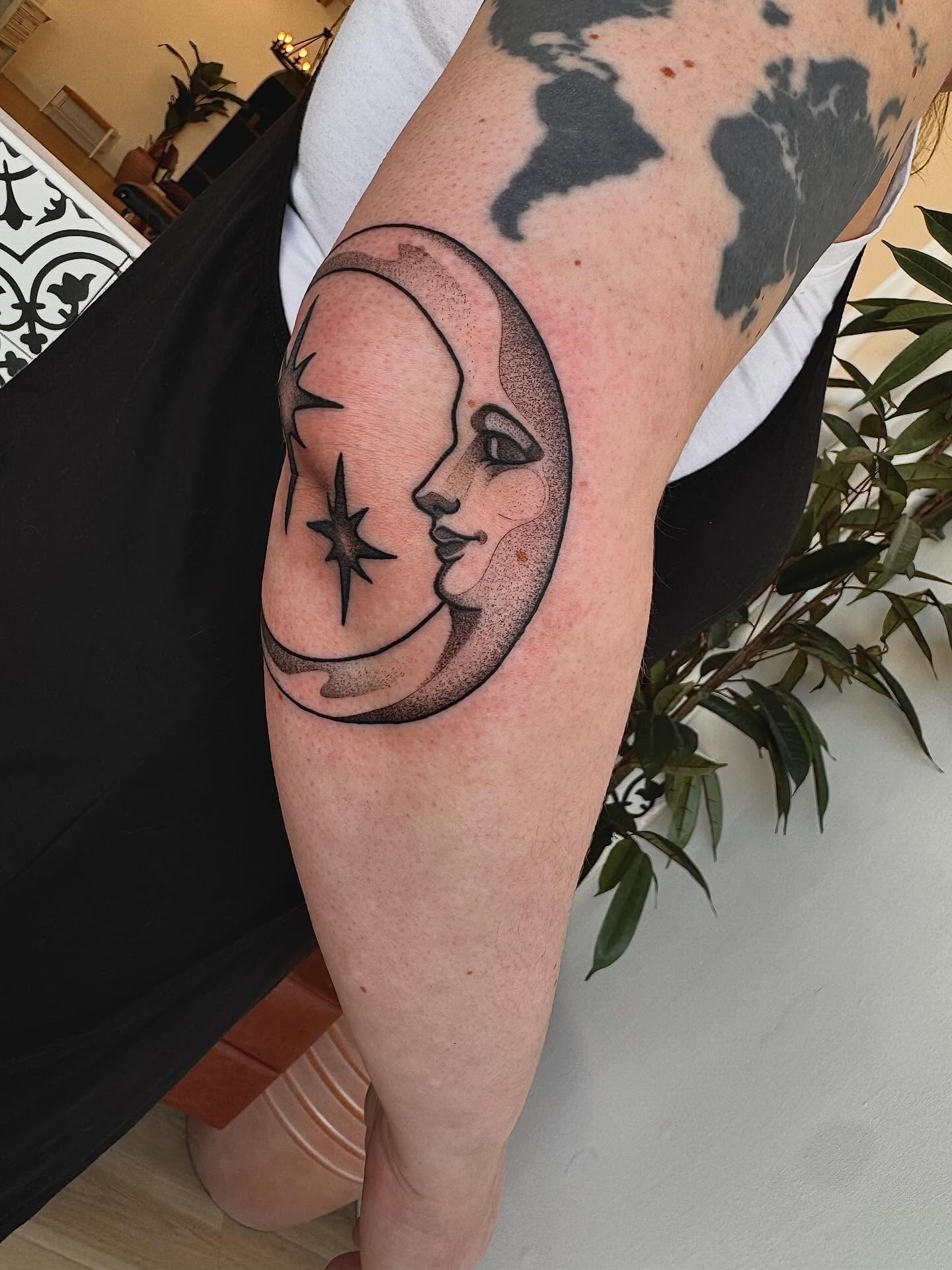 Moon and face dotwork tattoo on the forearm by Stefany