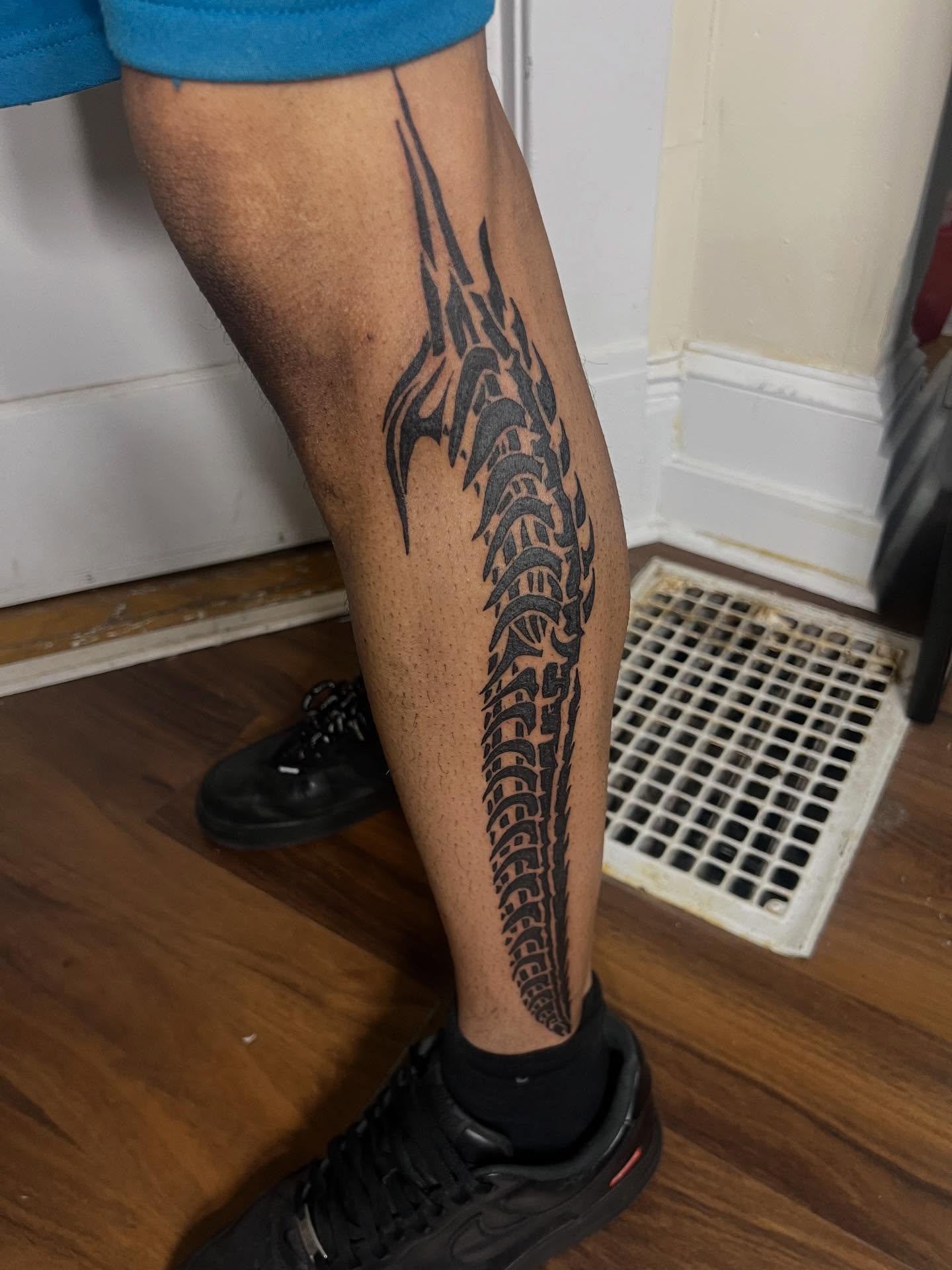 Spine tribal tattoo on the calf by Adam