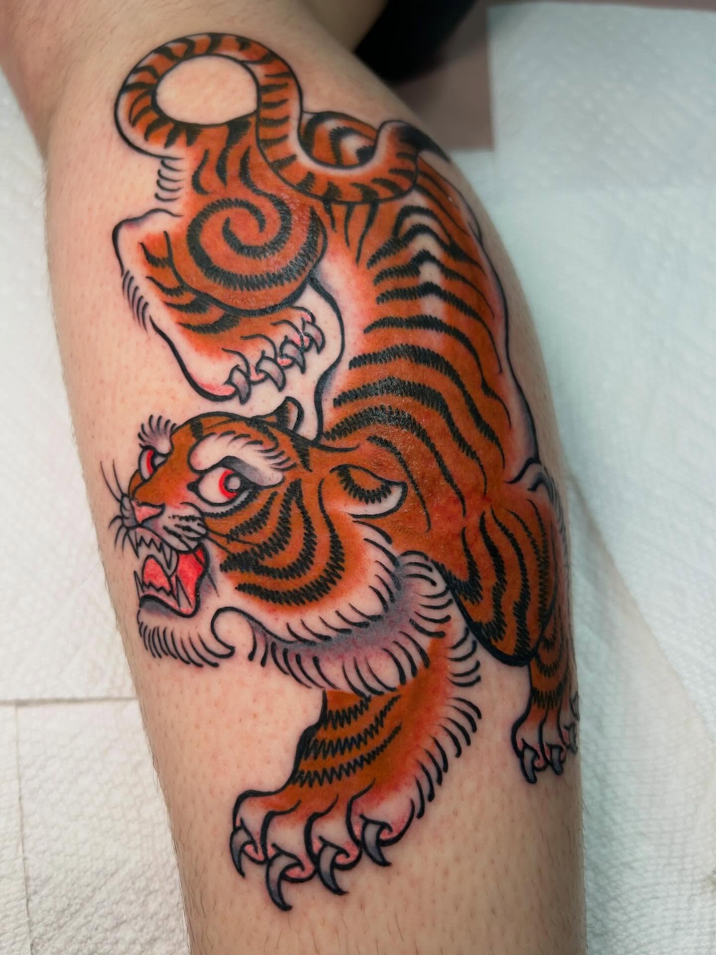 Tiger American traditional tattoo on the forearm by Katie Dexter, Des Moines, Iowa