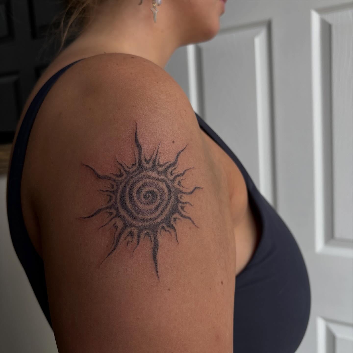 Sun black and grey tattoo on the shoulder by Hailey Nicole