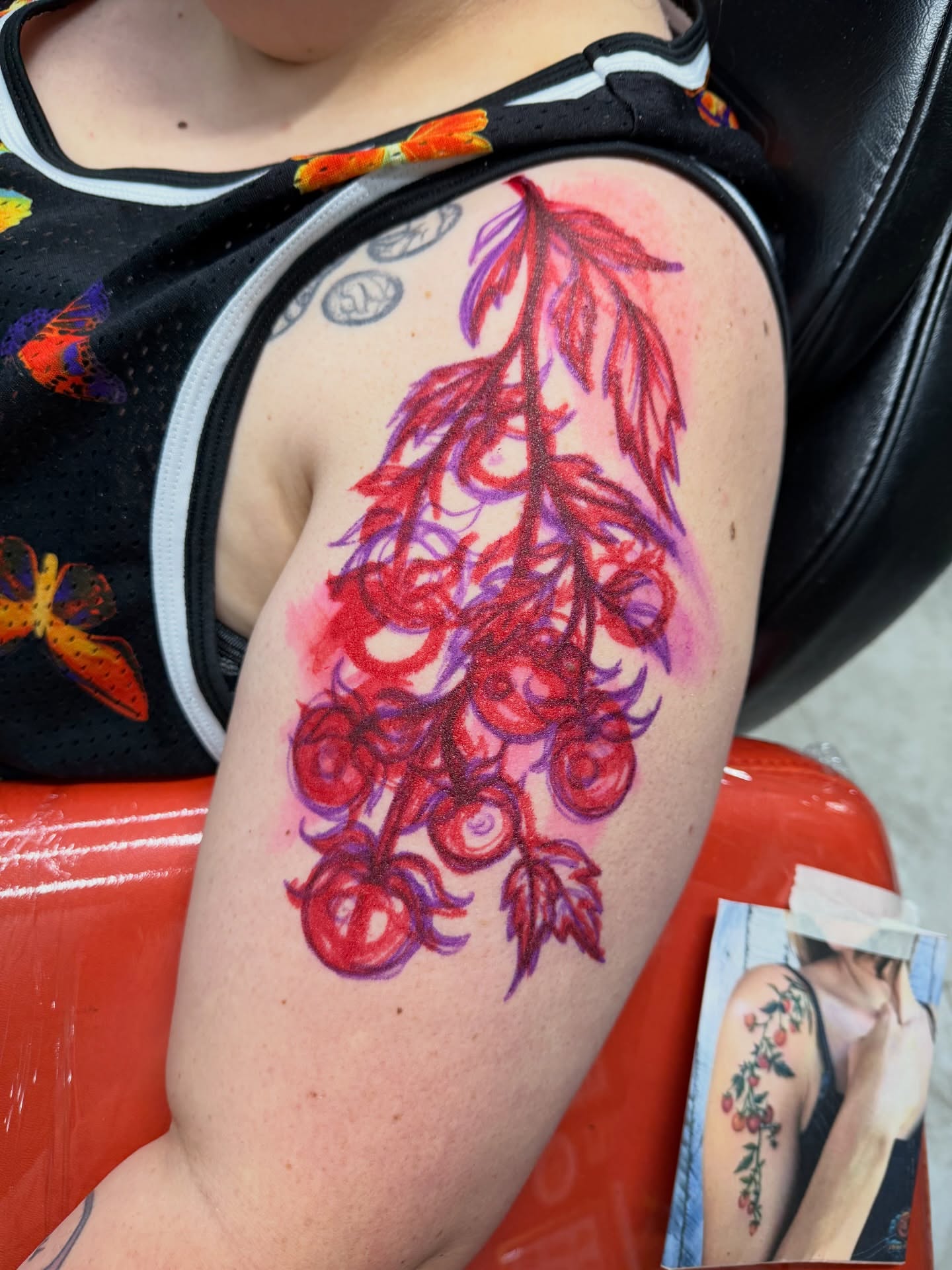 Flower cluster new school tattoo on the upper arm by Squid